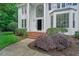 Inviting entrance to a lovely two-story home featuring a manicured lawn and shrubs at 12 Gatesway Ct, Durham, NC 27707
