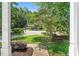 Well-kept front yard featuring a sidewalk, lush landscaping, and mature trees at 12 Gatesway Ct, Durham, NC 27707