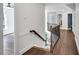 Bright hallway and staircase with beautiful hardwood floors and white walls at 12 Gatesway Ct, Durham, NC 27707