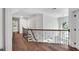 Light and bright hallway with hardwood floors and decorative railing at 12 Gatesway Ct, Durham, NC 27707