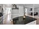 Well-lit kitchen with stainless steel appliances, white cabinets, and easy access to living areas at 12 Gatesway Ct, Durham, NC 27707