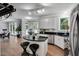 Stylish kitchen island with seating, black countertops, and modern appliances at 12 Gatesway Ct, Durham, NC 27707
