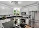 Bright kitchen features granite counters, stainless steel appliances, white cabinets, and sunlit windows at 12 Gatesway Ct, Durham, NC 27707