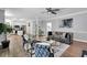 Open-concept living room with a sofa, accent chairs, and seamless flow to the kitchen area at 12 Gatesway Ct, Durham, NC 27707