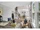 An open floor plan with a staircase, dining room, office, and a large window at 12 Gatesway Ct, Durham, NC 27707