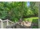Backyard patio area with a fire pit, surrounded by lush greenery at 12 Gatesway Ct, Durham, NC 27707