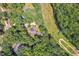 Overhead shot of a home surrounded by mature trees showcasing its secluded location and large lot at 126 Captains Ct, Durham, NC 27712