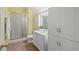 Bright bathroom featuring a glass enclosed shower, and white vanity with storage at 126 Captains Ct, Durham, NC 27712