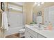 Well-lit bathroom featuring a shower-tub combo, spacious vanity, and modern fixtures at 126 Captains Ct, Durham, NC 27712