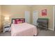 Cozy bedroom with unique decor, featuring a pink comforter and charming writing desk at 126 Captains Ct, Durham, NC 27712