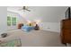 Spacious bedroom with large play area and natural light, featuring a ceiling fan at 126 Captains Ct, Durham, NC 27712