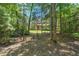 Beautiful single story home with stone and siding accents nestled among mature trees at 126 Captains Ct, Durham, NC 27712