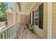 This covered front porch has white rails and black shutters for a sophisticated look and outdoor seating at 126 Captains Ct, Durham, NC 27712