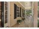 Relax on this cozy covered front porch with views of the green outdoors and a lovely seating area at 126 Captains Ct, Durham, NC 27712