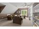 Cozy living room with plush seating, complemented by built-in shelving and a window view at 126 Captains Ct, Durham, NC 27712