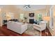 Elegant living room with hardwood floors, fireplace, natural light, and a smooth transition to the dining room at 126 Captains Ct, Durham, NC 27712