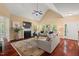 Sunlit living room showcasing high ceilings, fireplace, hardwood floors and access to outdoor views at 126 Captains Ct, Durham, NC 27712