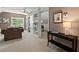 Inviting living room featuring a comfortable chair, built-in bookshelves, and abundant natural light at 126 Captains Ct, Durham, NC 27712