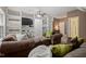 Spacious living room featuring comfortable sofas, built-in shelving, and a ceiling fan at 126 Captains Ct, Durham, NC 27712