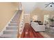 Spacious living room features hardwood floors, vaulted ceilings and an adjacent staircase at 126 Captains Ct, Durham, NC 27712