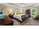 Spacious main bedroom featuring tray ceilings and large windows for natural light at 126 Captains Ct, Durham, NC 27712