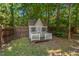 Charming playhouse in the backyard with fenced in yard and wooded backdrop at 126 Captains Ct, Durham, NC 27712