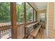 Screened-in porch with grill and wood furniture at 126 Captains Ct, Durham, NC 27712