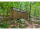 Exterior view of the storage shed located on this wooded property at 126 Captains Ct, Durham, NC 27712