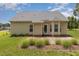 Exterior backyard view of a home featuring a patio and lush green lawn at 127 Strike Eagle Dr, Broadway, NC 27505