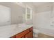 Bathroom featuring a vanity, mirror, bathtub, and natural light from a window at 127 Strike Eagle Dr, Broadway, NC 27505
