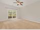 Spacious bedroom with neutral carpet, a ceiling fan, and a bright window at 127 Strike Eagle Dr, Broadway, NC 27505