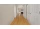 Inviting hallway features hardwood floors and leads to a bright living area with a fireplace, offering a warm welcome at 127 Strike Eagle Dr, Broadway, NC 27505