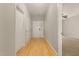 Bright hallway with hardwood floors, neutral paint, and ample closet space leads to the front door and living areas at 127 Strike Eagle Dr, Broadway, NC 27505