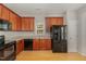 View of a well-lit kitchen with black appliances and a window over the sink at 127 Strike Eagle Dr, Broadway, NC 27505