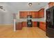 Well-lit kitchen featuring wood cabinets, modern black appliances, and an open layout at 127 Strike Eagle Dr, Broadway, NC 27505