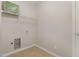 A small laundry room with tile floors, open shelving, and washer/dryer hookups at 127 Strike Eagle Dr, Broadway, NC 27505