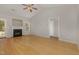 Spacious living room with hardwood floors, fireplace, and large windows offers ample natural light and a cozy atmosphere at 127 Strike Eagle Dr, Broadway, NC 27505