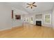 Open-concept living room features hardwood floors, fireplace, and seamless flow into the adjacent kitchen, perfect for entertaining at 127 Strike Eagle Dr, Broadway, NC 27505