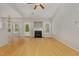 Bright living room boasts hardwood floors, fireplace, and ample natural light, creating a welcoming and airy atmosphere at 127 Strike Eagle Dr, Broadway, NC 27505