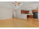 Open living space with hardwood floors flowing into the kitchen, complete with wooden cabinets and stainless steel appliances at 127 Strike Eagle Dr, Broadway, NC 27505