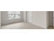 Bright bedroom features carpeted floors, a window with blinds, and white trim at 134 Rusling Leaf Dr, Fuquay Varina, NC 27526