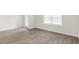 Bright bedroom features wood-look floors, white walls, and a large window for natural light at 134 Rusling Leaf Dr, Fuquay Varina, NC 27526