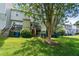 View of a townhouse backyard with stairs leading to decks and a green lawn at 14 Quintin Pl, Durham, NC 27705