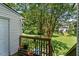 Backyard features a deck, stairs, mature trees, and lawn at 14 Quintin Pl, Durham, NC 27705