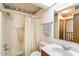 Bright bathroom has a skylight, shower with white curtain and a neutral color scheme at 14 Quintin Pl, Durham, NC 27705