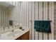 Cozy bathroom with classic wallpaper, ample lighting and a well-placed mirror at 14 Quintin Pl, Durham, NC 27705