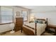 Bright bedroom features wooden accents, blinds, a beige color scheme, and a tall dresser at 14 Quintin Pl, Durham, NC 27705