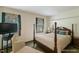 Traditional bedroom features four-poster bed, neutral tones, and sunlit windows at 14 Quintin Pl, Durham, NC 27705