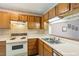 Well-lit kitchen featuring wood cabinets, and modern appliances at 14 Quintin Pl, Durham, NC 27705