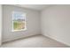A room featuring a window with blinds, carpet flooring, and neutral-color walls at 142 Rusling Leaf Dr, Fuquay Varina, NC 27526